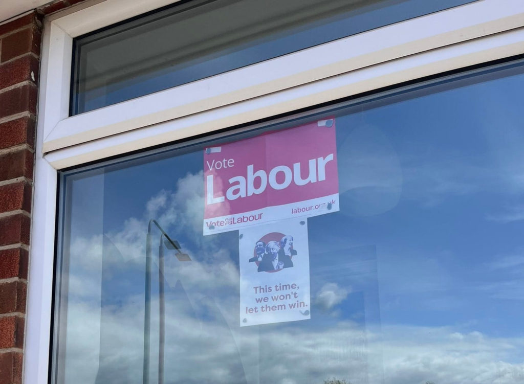 My Gedling campaign poster stuck on a window under a vote Labour poster